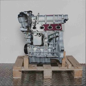 Seitenansicht eines silberfarbenen Motors BLF auf einer Holzpalette vor weißem Hintergrund. Alle Komponenten des Motors sind deutlich erkennbar.